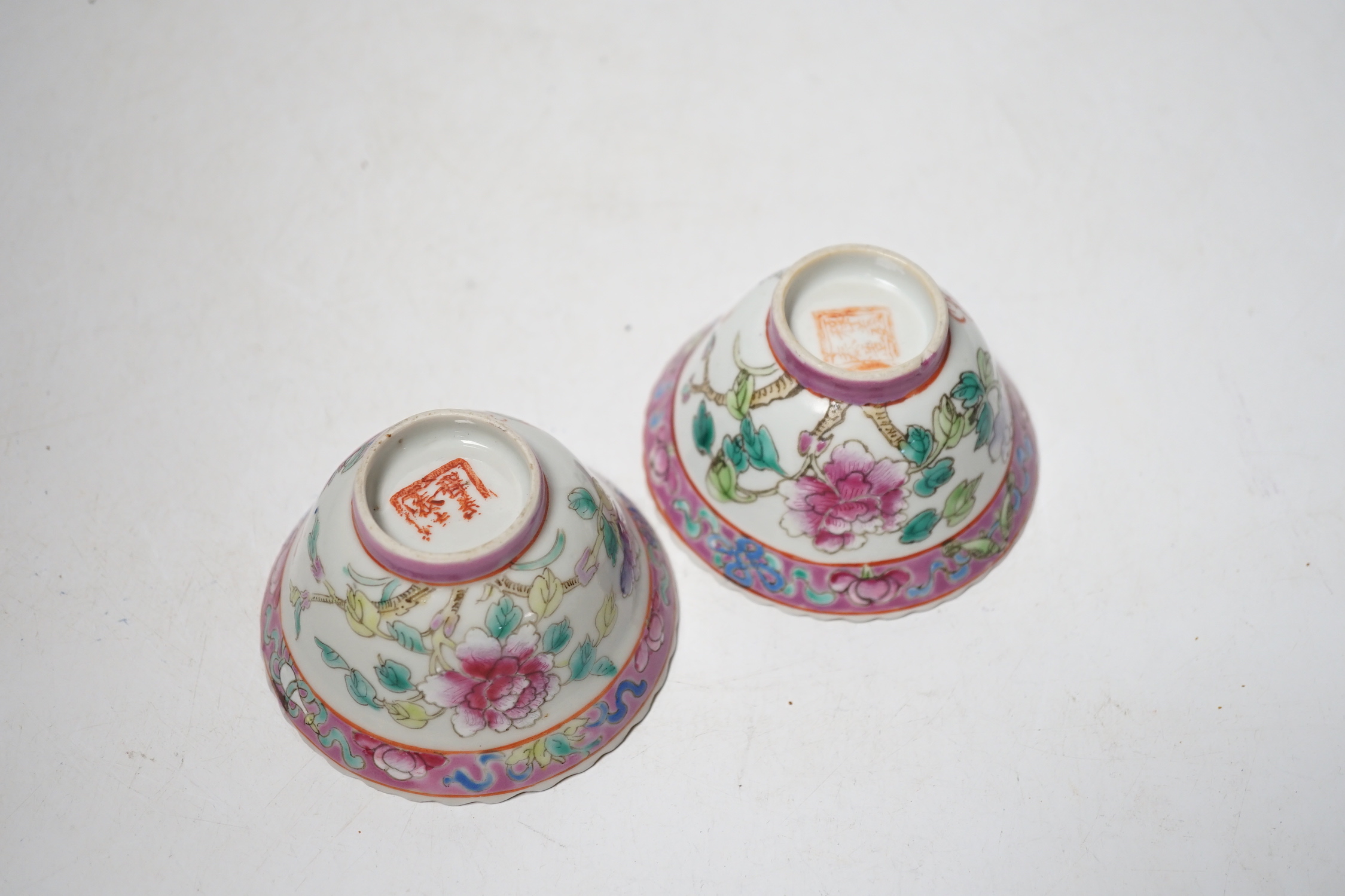 A pair of Chinese Straits famille rose pink ground bowls, Nonya ware, late 19th century, 5.5cm high